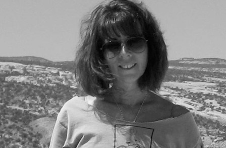 Black and white headshot of poet Wendy Videlock on top of a hill.